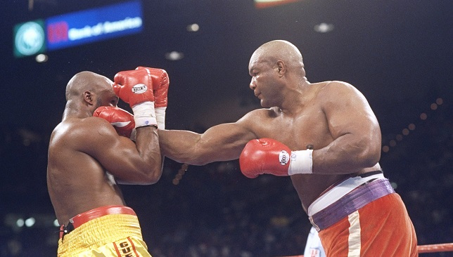 George Foreman lands a straight right on Michael Moorer.