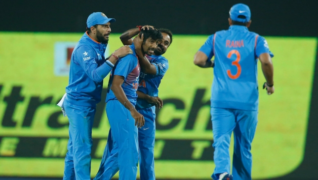 Bumrah is mobbed by teammates after the brilliant final over.