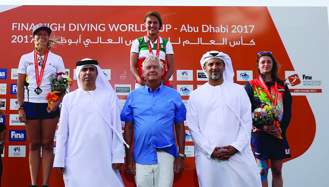 Golden girl: Jimenez (top centre) at the medal ceremony in Abu Dhabi.