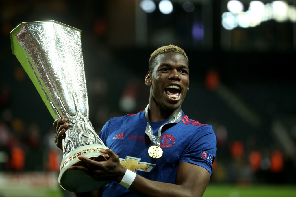 Manchester United's French midfielder Paul Pogba celebrates with the trophy after his team won the UEFA Europa League final football match Ajax Amsterdam v Manchester United on May 24, 2017 at the Friends Arena in Solna outside Stockholm. / AFP PHOTO / Soren Andersson        (Photo credit should read SOREN ANDERSSON/AFP/Getty Images)