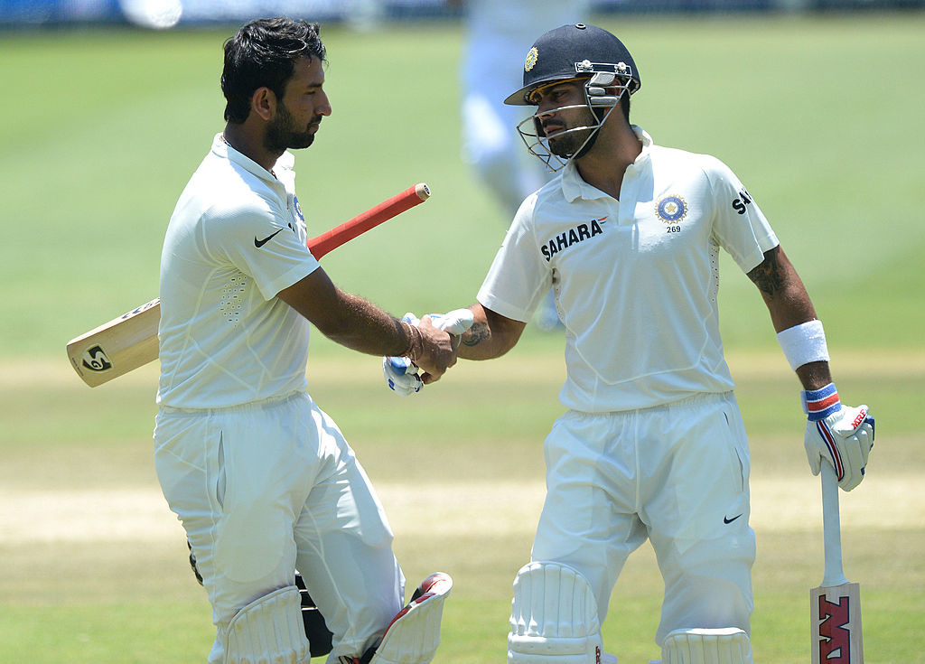 Pujara is congratulated by Kohli agter his innings of 153