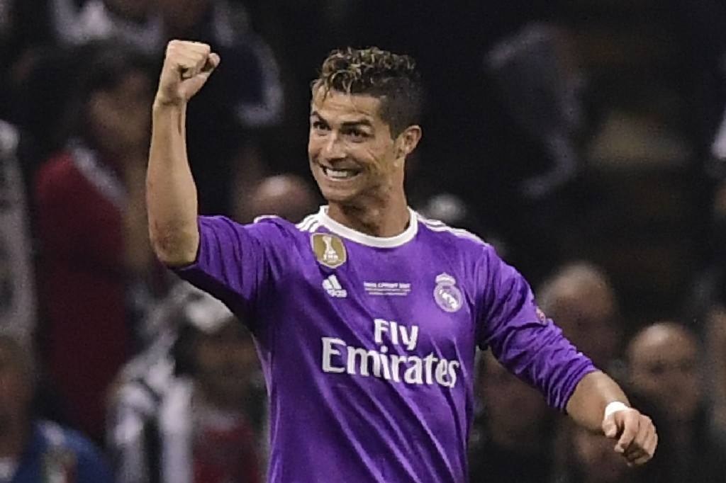 Real Madrid's Portuguese striker Cristiano Ronaldo celebrates after scoring the opening goal of the UEFA Champions League final football match between Juventus and Real Madrid at The Principality Stadium in Cardiff, south Wales, on June 3, 2017. / AFP PHOTO / Javier SORIANO (Photo credit should read JAVIER SORIANO/AFP/Getty Images)