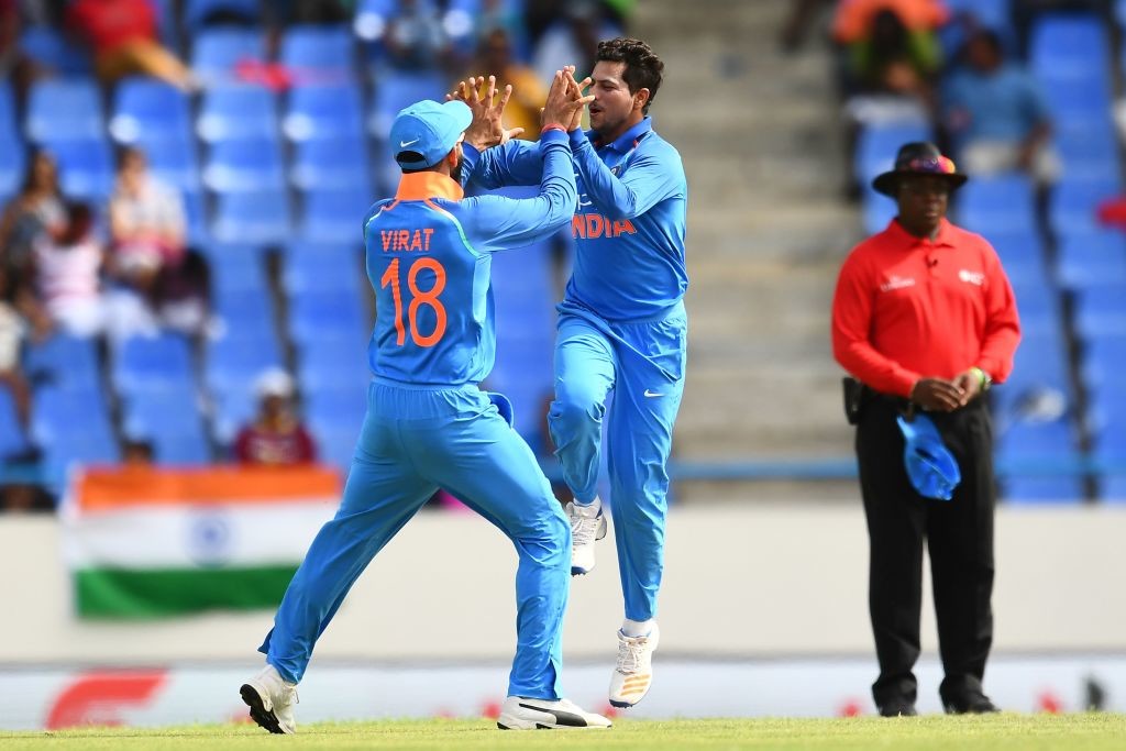 India's Kuldeep Yadav (C) celebrates with team captain Virat Kohli after bowling out West Indies' Roston Chase during the third One Day International (ODI) match between West Indies and India, at the Sir Vivian Richards Cricket Ground in St. John's, Antigua, on June 30, 2107. / AFP PHOTO / Jewel SAMAD (Photo credit should read JEWEL SAMAD/AFP/Getty Images)