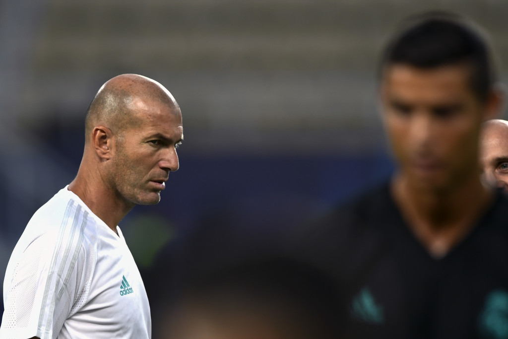 Real Madrid's French coach Zinedine Zidane looks at Real Madrid's forward Cristiano Ronaldo (R) during a training session ahead of the UEFA Super Cup 2017 football match between Real Madrid and Manchester United at The National Arena Filip II in Skopje on August 7, 2017. / AFP PHOTO / DIMITAR DILKOFF (Photo credit should read DIMITAR DILKOFF/AFP/Getty Images)