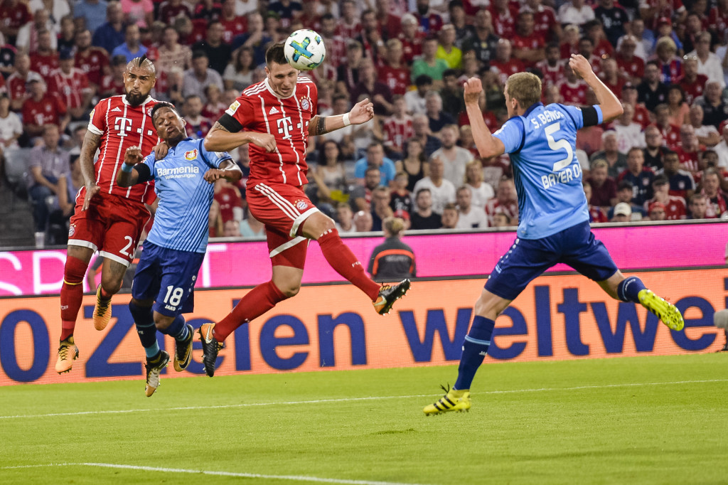 Bayern Munich's defender Niklas Suele heads the ball to score the opening goal of the season during the German First division Bundesliga football match FC Bayern Munich vs Bayer 04 Leverkusen in Munich, southern Germany, on August 18, 2017. / AFP PHOTO / Guenter SCHIFFMANN / RESTRICTIONS: DURING MATCH TIME: DFL RULES TO LIMIT THE ONLINE USAGE TO 15 PICTURES PER MATCH AND FORBID IMAGE SEQUENCES TO SIMULATE VIDEO. == RESTRICTED TO EDITORIAL USE == FOR FURTHER QUERIES PLEASE CONTACT DFL DIRECTLY AT + 49 69 650050 / RESTRICTIONS: DURING MATCH TIME: DFL RULES TO LIMIT THE ONLINE USAGE TO 15 PICTURES PER MATCH AND FORBID IMAGE SEQUENCES TO SIMULATE VIDEO. == RESTRICTED TO EDITORIAL USE == FOR FURTHER QUERIES PLEASE CONTACT DFL DIRECTLY AT + 49 69 650050 (Photo credit should read GUENTER SCHIFFMANN/AFP/Getty Images)