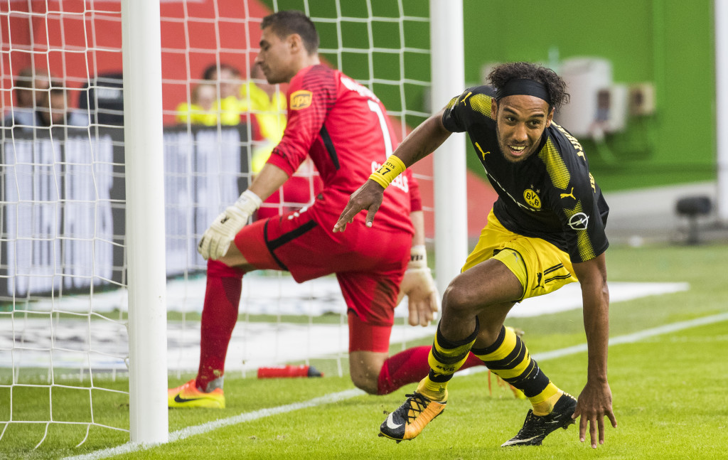 Dortmund's Gabonese forward Pierre-Emerick Aubameyang (R) celebrates scoring his side's third goal past Wolfsburg's Belgian goalkeeper Koen Casteels during the German First division Bundesliga football match VfL Wolfsburg v BVB Borussia Dortmund in Wolfsburg, western Germany on August 19, 2017. / AFP PHOTO / Odd ANDERSEN / RESTRICTIONS: DURING MATCH TIME: DFL RULES TO LIMIT THE ONLINE USAGE TO 15 PICTURES PER MATCH AND FORBID IMAGE SEQUENCES TO SIMULATE VIDEO. == RESTRICTED TO EDITORIAL USE == FOR FURTHER QUERIES PLEASE CONTACT DFL DIRECTLY AT + 49 69 650050 (Photo credit should read ODD ANDERSEN/AFP/Getty Images)
