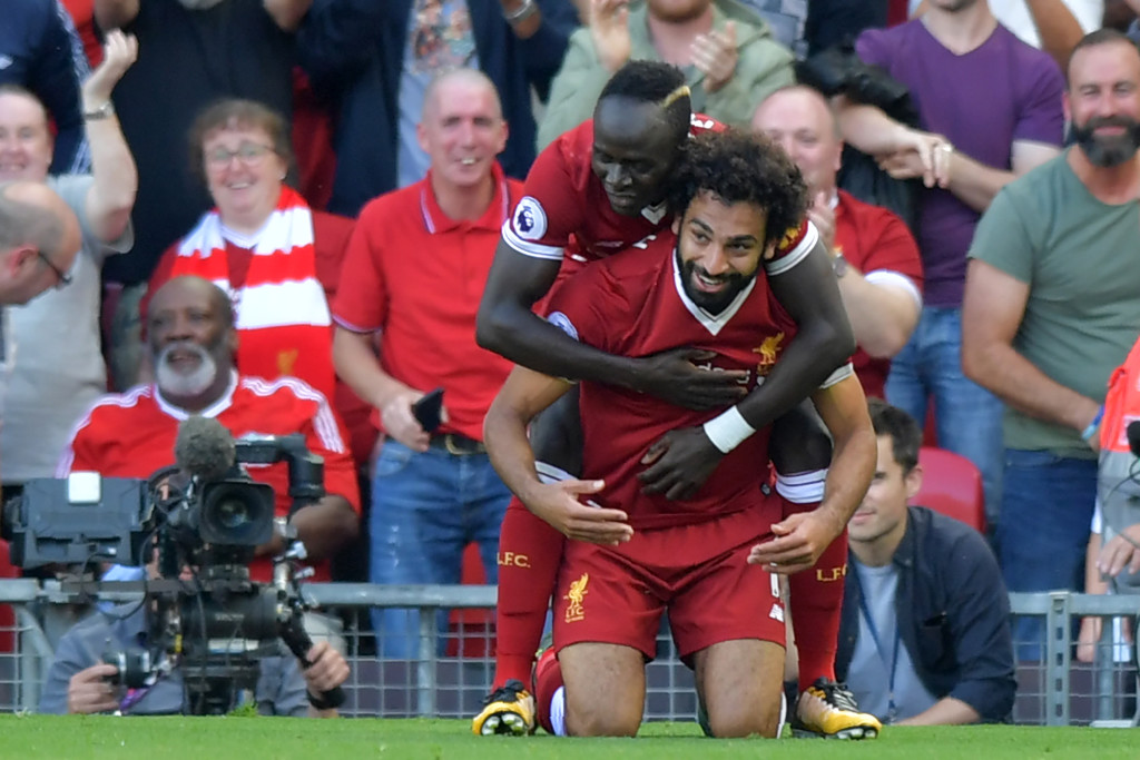 Liverpool's Egyptian midfielder Mohamed Salah (R) celebrates with Liverpool's Senegalese midfielder Sadio Mane after scoring their third goal during the English Premier League football match between Liverpool and Arsenal at Anfield in Liverpool, north west England on August 27, 2017. / AFP PHOTO / Anthony Devlin / RESTRICTED TO EDITORIAL USE. No use with unauthorized audio, video, data, fixture lists, club/league logos or 'live' services. Online in-match use limited to 75 images, no video emulation. No use in betting, games or single club/league/player publications. / (Photo credit should read ANTHONY DEVLIN/AFP/Getty Images)