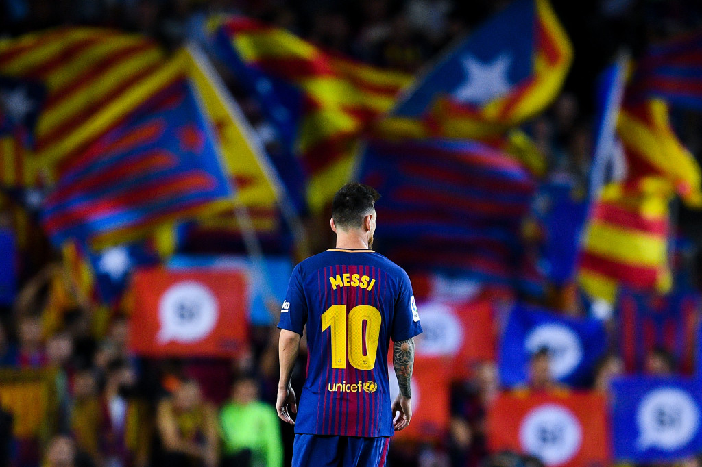 BARCELONA, SPAIN - SEPTEMBER 19: Lionel Messi of FC Barcelona looks on as Catalan Pro-Independence flags are seen on the background during the La Liga match between Barcelona and SD Eibar at Camp Nou on September 19, 2017 in Barcelona, Spain. (Photo by David Ramos/Getty Images)