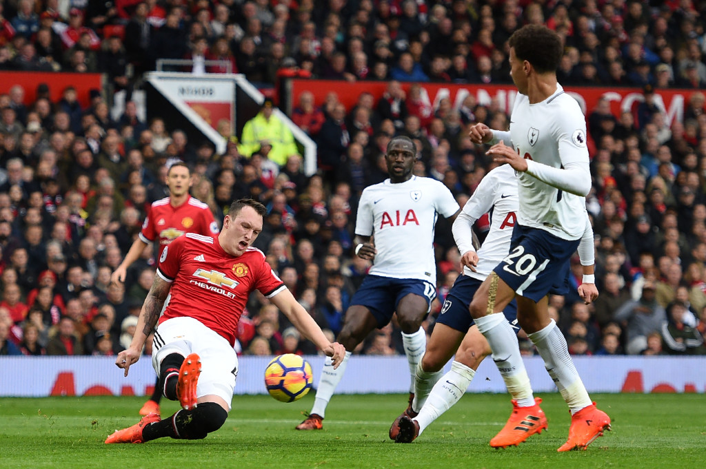 Jones clears the ball in a resolute display for United