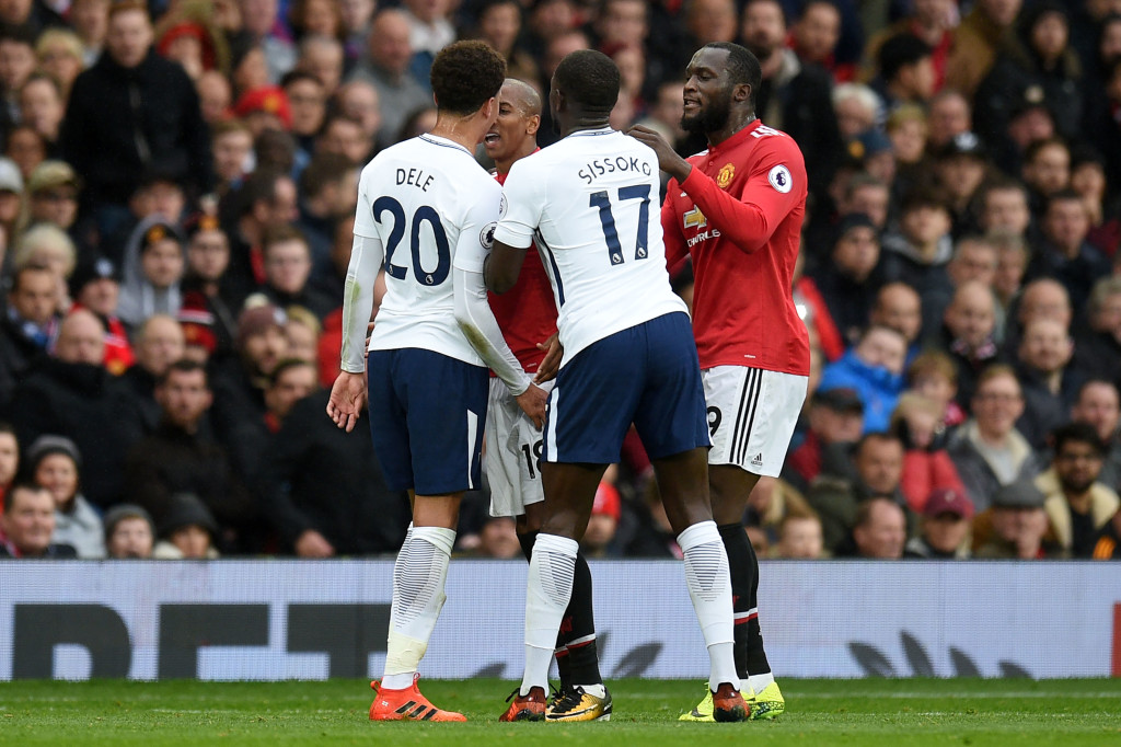 Tottenham Hotspur's French midfielder Moussa Sissoko (2nd R) and Manchester United's Belgian striker Romelu Lukaku (R) act as peace-makers in a confrontation between Tottenham Hotspur's English midfielder Dele Alli (L) and Manchester United's English midfielder Ashley Young (2nd L) during the English Premier League football match between Manchester United and Tottenham Hotspur at Old Trafford in Manchester, north west England, on October 28, 2017. / AFP PHOTO / Oli SCARFF / RESTRICTED TO EDITORIAL USE. No use with unauthorized audio, video, data, fixture lists, club/league logos or 'live' services. Online in-match use limited to 75 images, no video emulation. No use in betting, games or single club/league/player publications. / (Photo credit should read OLI SCARFF/AFP/Getty Images)