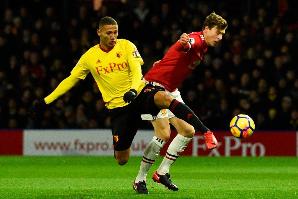 Victor Lindelof (R) cuts across to defend