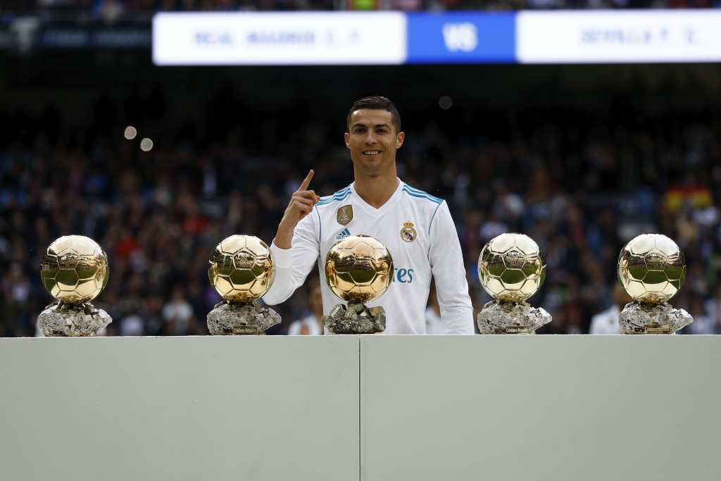 Cristiano Ronaldo poses with his five Ballon d'Or trophies