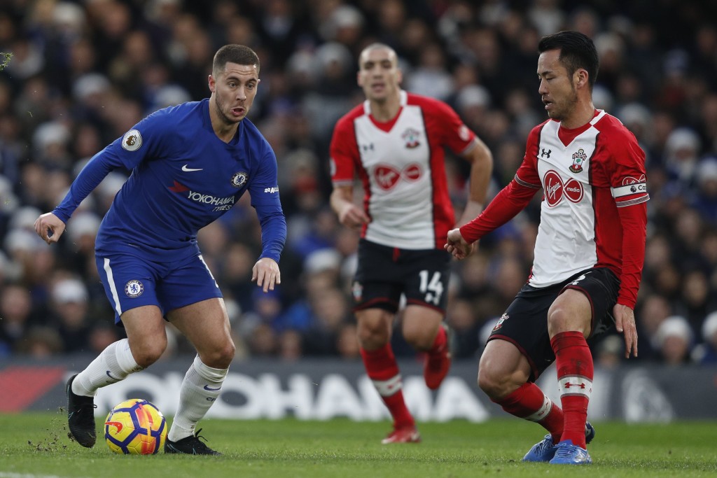 Chelsea's Belgian midfielder Eden Hazard (L) vies with Southampton's Japanese defender Maya Yoshida during the English Premier League football match between Chelsea and Southampton at Stamford Bridge in London on December 16, 2017. / AFP PHOTO / Adrian DENNIS / RESTRICTED TO EDITORIAL USE. No use with unauthorized audio, video, data, fixture lists, club/league logos or 'live' services. Online in-match use limited to 75 images, no video emulation. No use in betting, games or single club/league/player publications. / (Photo credit should read ADRIAN DENNIS/AFP/Getty Images)