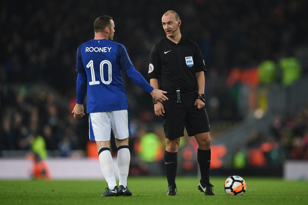 Everton's English striker Wayne Rooney (L) gestures as he talks with Referee Robert Madley (R) during the English FA Cup third round football match between Liverpool and Everton at Anfield in Liverpool, north west England on January 5, 2018. / AFP PHOTO / Paul ELLIS / RESTRICTED TO EDITORIAL USE. No use with unauthorized audio, video, data, fixture lists, club/league logos or 'live' services. Online in-match use limited to 75 images, no video emulation. No use in betting, games or single club/league/player publications. / (Photo credit should read PAUL ELLIS/AFP/Getty Images)