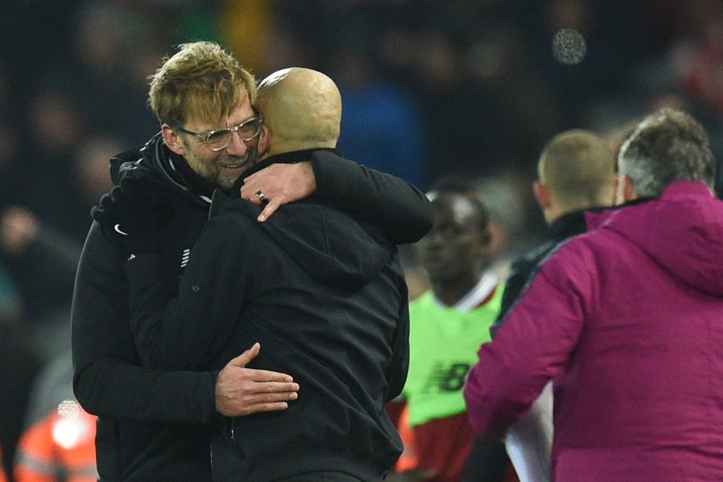 Liverpool's German manager Jurgen Klopp (L) embraces Manchester City's Spanish manager Pep Guardiola (R) at the end of the English Premier League football match between Liverpool and Manchester City at Anfield in Liverpool, north west England on January 14, 2018. / AFP PHOTO / Oli SCARFF / RESTRICTED TO EDITORIAL USE. No use with unauthorized audio, video, data, fixture lists, club/league logos or 'live' services. Online in-match use limited to 75 images, no video emulation. No use in betting, games or single club/league/player publications.  /         (Photo credit should read OLI SCARFF/AFP/Getty Images)