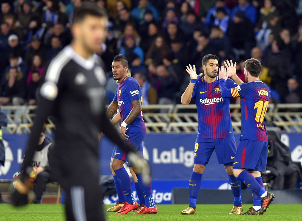 Barcelona's Uruguayan forward Luis Suarez (2R) celebrates a goal with Barcelona's Argentinian forward Lionel Messi during the Spanish league football match between Real Sociedad and FC Barcelona at the Anoeta stadium in San Sebastian on January 14, 2018. / AFP PHOTO / ANDER GILLENEA (Photo credit should read ANDER GILLENEA/AFP/Getty Images)