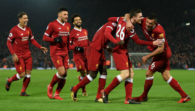 Liverpool players celebrate a goal against Man City.