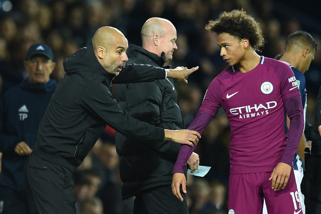 Leroy Sane receives instructions from Pep Guardiola.