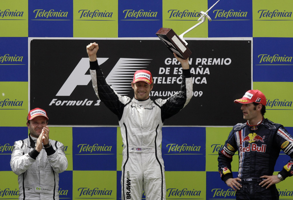 Jenson Button (C) celebrates with team-mate Rubens Barrichello (L)