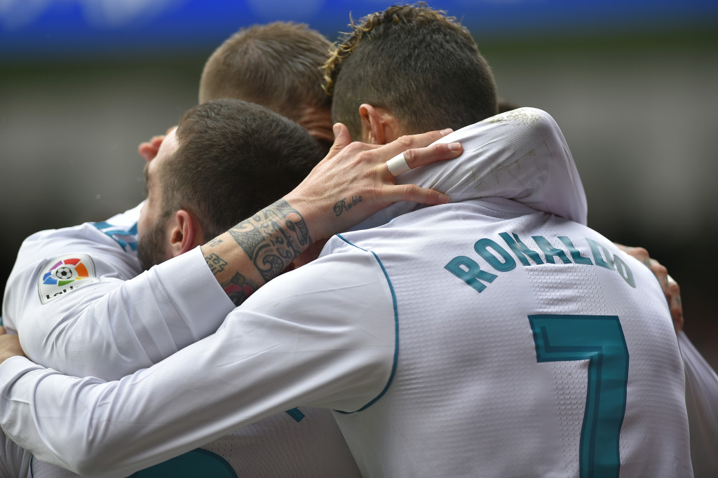 Real Madrid's Portuguese forward Cristiano Ronaldo (R) celebrates with teammates after scoring his team's second goal during the Spanish league football match between Eibar and Real Madrid at the Ipurua stadium in Eibar on March 10, 2018. / AFP PHOTO / ANDER GILLENEA (Photo credit should read ANDER GILLENEA/AFP/Getty Images)