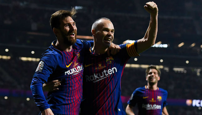 Andres Iniesta of FC Barcelona celebrates with his team mate Lionel Messi