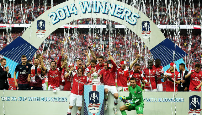 Arsenal players celebrate victory with the trophy after the FA Cup