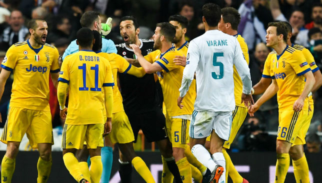 Buffon of Juventus argues with the referee Michael Oliver