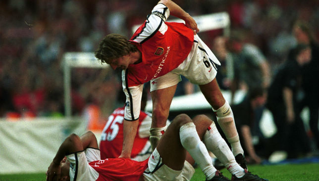 Thierry Henry of Arsenal is consoled by Tony Adams