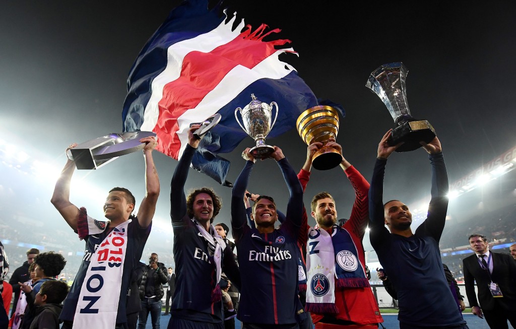 (from L) Paris Saint-Germain's German midfielder Julian Draxler, Paris Saint-Germain's French midfielder Adrien Rabiot, Paris Saint-Germain's Brazilian defender Thiago Silva, Paris Saint-Germain's German goalkeeper Kevin Trapp and Paris Saint-Germain's French defender Layvin Kurzawa celebrate with a trophy after winning the French L1 title at the end of the French L1 football match Paris Saint-Germain (PSG) vs Rennes on May 12, 2018 at the Parc des Princes stadium in Paris. (Photo by FRANCK FIFE / AFP) (Photo credit should read FRANCK FIFE/AFP/Getty Images)