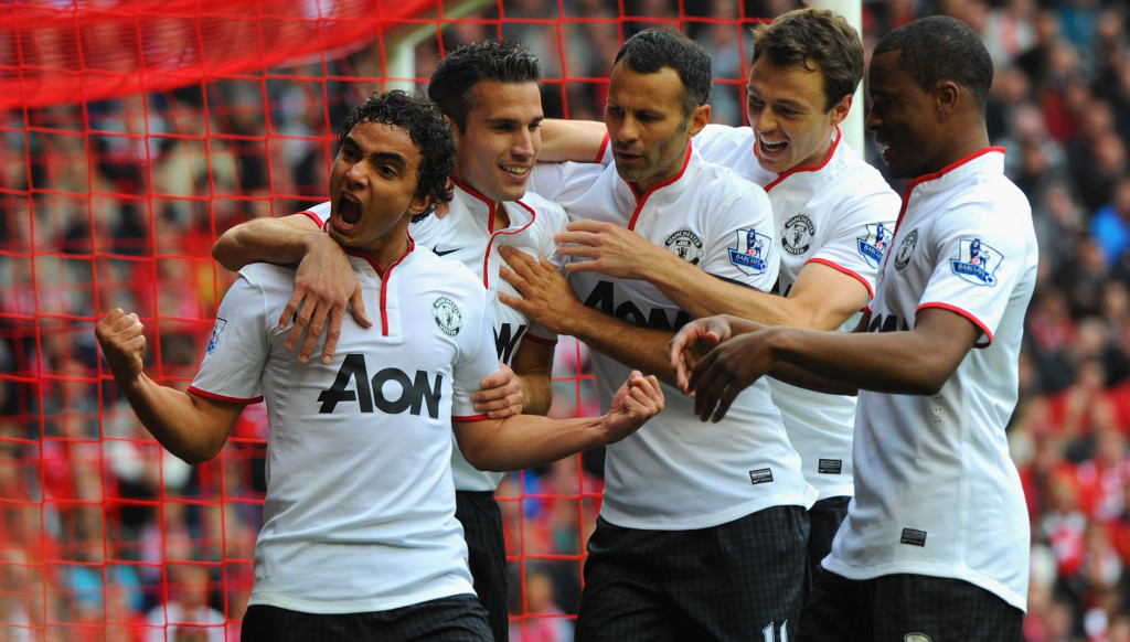 Rafael celebrates with United teammates after scoring sublimely against Liverpool.
