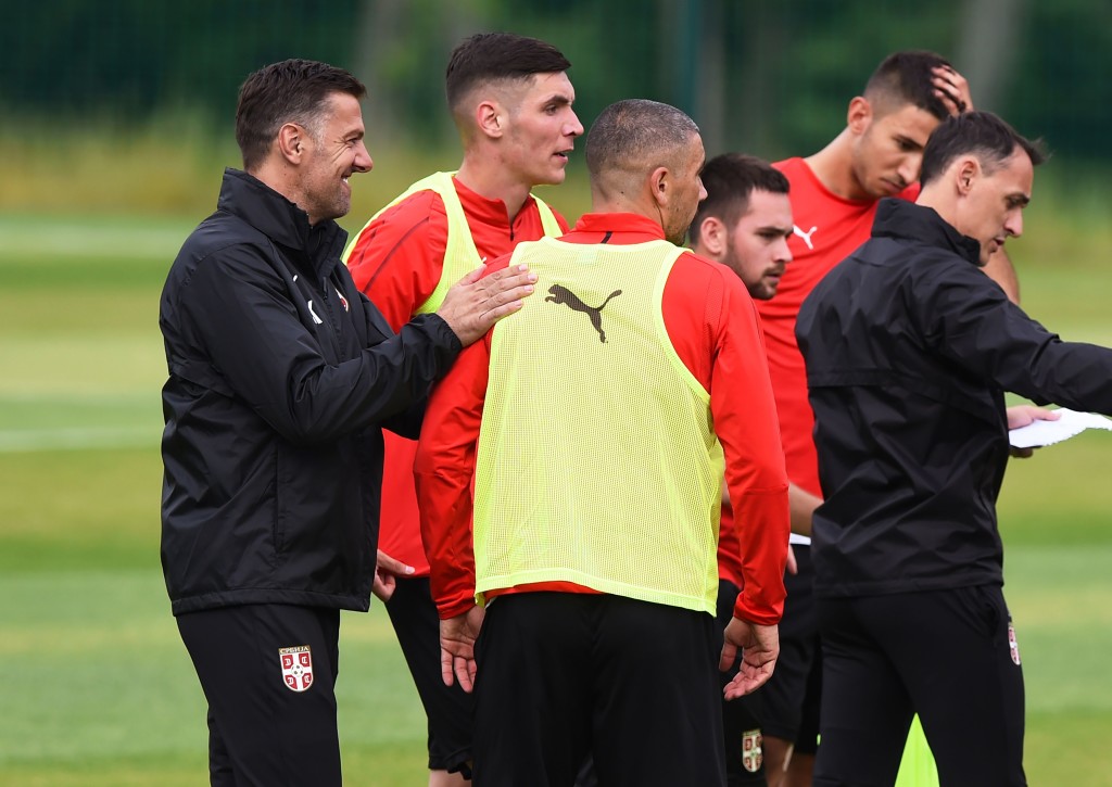 Serbia's coach Mladen Krstajic (L) jokes with his players during a training session at Serbia's national football team base camp in Svetlogorsk, some 50 km north of Kaliningrad, on June 12, 2018, ahead of the Russia 2018 World Cup football tournament. (Photo by Attila KISBENEDEK / AFP) (Photo credit should read ATTILA KISBENEDEK/AFP/Getty Images)