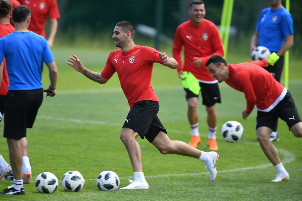Serbia's forward Aleksandar Mitrovic (C) runs past teammates during a training session at Serbia's national football team's base camp in Svetlogorsk, some 50 km north of Kaliningrad, on June 14, 2018, ahead of the Russia 2018 World Cup football tournament. (Photo by Attila KISBENEDEK / AFP) (Photo credit should read ATTILA KISBENEDEK/AFP/Getty Images)