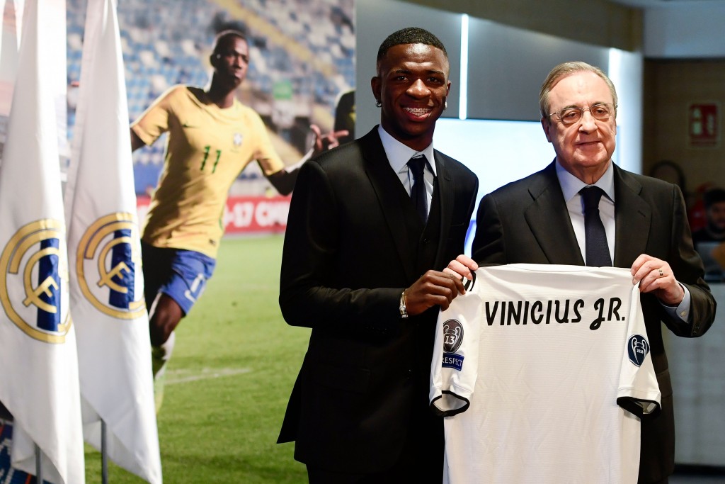 Real Madrid's new Brazilian forward Vinicius Junior (L) holds his new jersey as he poses with Real Madrid president Florentino Perez during his official presentation at the Santiago Bernabeu Stadium in Madrid on July 20, 2018. (Photo by PIERRE-PHILIPPE MARCOU / AFP) (Photo credit should read PIERRE-PHILIPPE MARCOU/AFP/Getty Images)