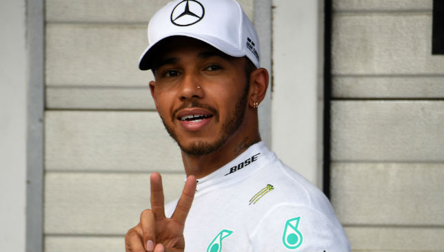 Hamilton flashes the sign of victory