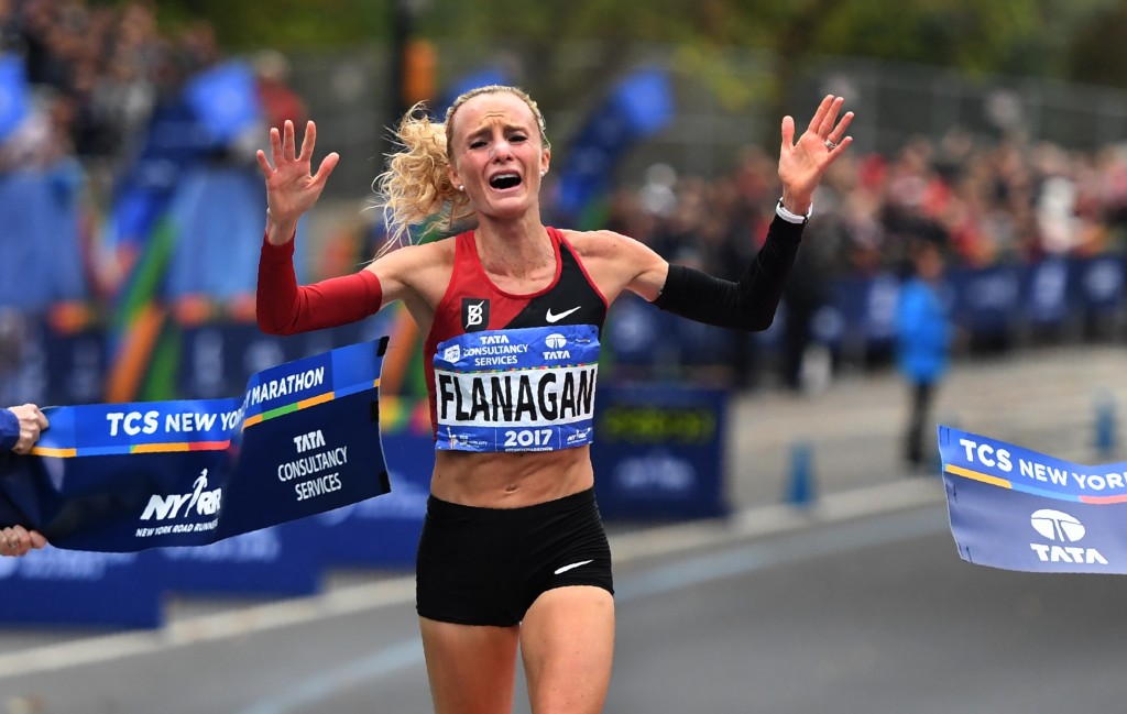 TOPSHOT - Shalane Flanagan of the US celebrates after crossing the finish line to win the Women's Division during the 2017 TCS New York City Marathon in New York on November 5, 2017. Five days after the worst attack on New York since September 11, 2001, the city is staging a show of defiance on November 5, as 50,000 runners from around the world are set to participate in the New York Marathon, under heavy security. / AFP PHOTO / TIMOTHY A. CLARY (Photo credit should read TIMOTHY A. CLARY/AFP/Getty Images)