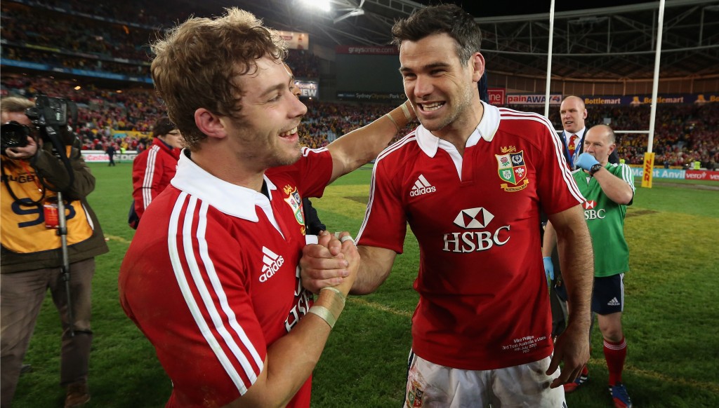Mike Phillips celebrates with compatriot Leigh Halfpenny after the British & Irish Lions secured a series win over Australia in 2013.