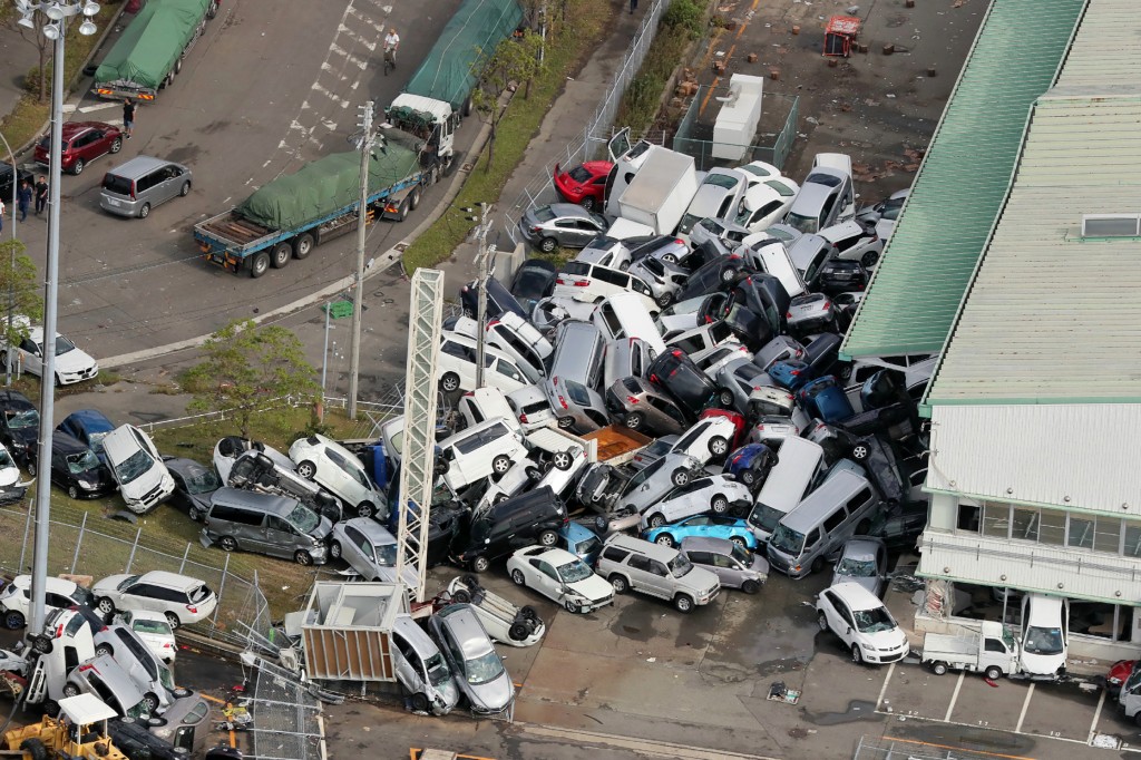 Vehicles piled in a heap due to strong winds in Kobe, Hyogo prefecture on September 5, 2018.