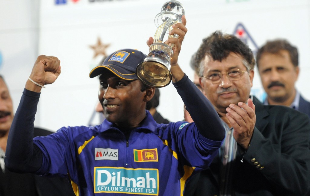 Sri Lanka cricket team captain Mahela Jayawardene (L) gestures after receiving the Asia Cup trophy from Pakistan President Parvez Musharraf (R) during the award ceremony of the Asia Cup between India and Sri Lanka at National stadium in Karachi on July 06, 2008. Sri Lanka won by defeating India by 100 runs . AFP PHOTO/ Asif HASSAN (Photo credit should read ASIF HASSAN/AFP/Getty Images)