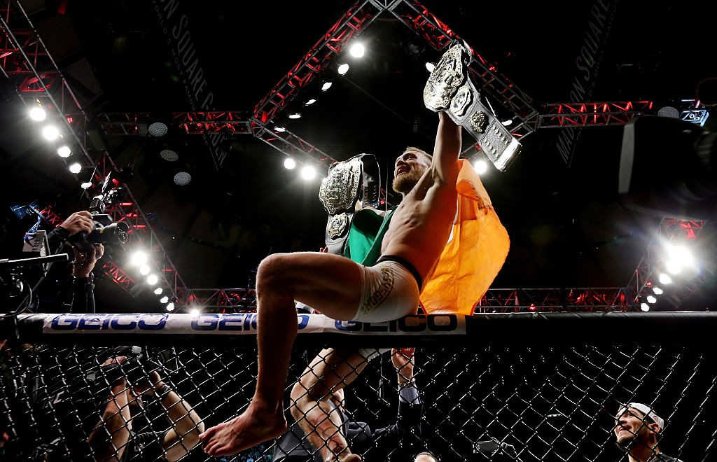 Conor McGregor celebrates after becoming lightweight champion