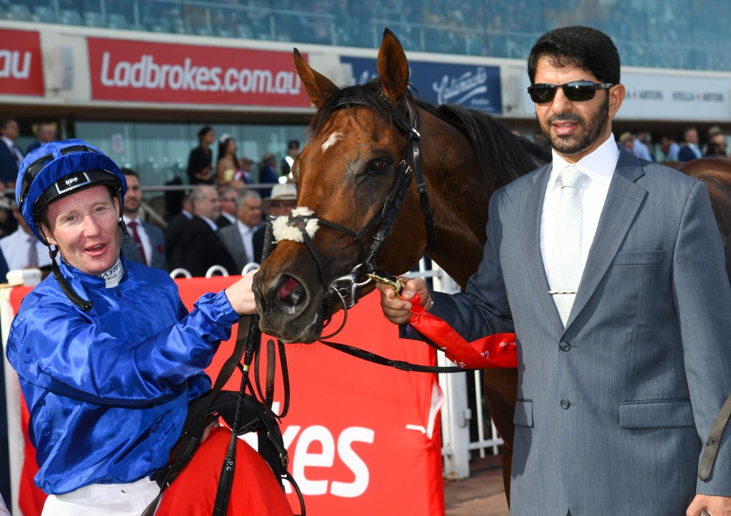 Jockey Pat Cosgrave poses with trainer Saeed Bin Suroor (r) after riding Benbatl to win the Caulfield Stakes