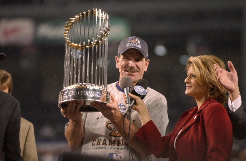 Manager Bob Brenly of the Arizona Diamondbacks holds the trophy after Game 7