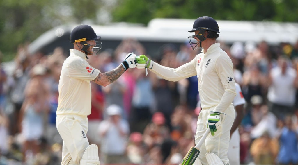 England batsman Ben Stokes reaches his 50 and is congratulated by Keaton Jennings (r)