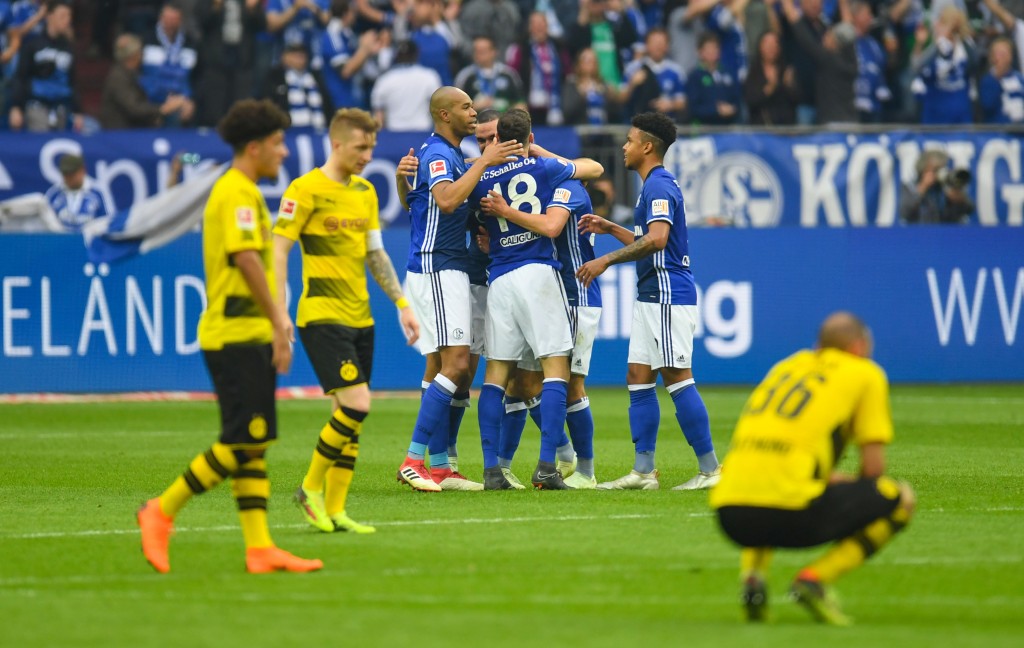 Players react after the German first division Bundesliga football match FC Schalke 04 vs Borussia Dortmund, in Gelsenkirchen