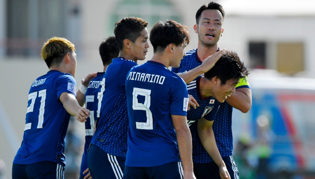 Yoshida (back, far r) celebrates after Takehiro Tomiyasu's goal against Saudi.