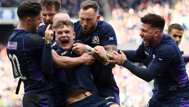 Darcy Graham celebrates his try against Wales with Scottish team-mates.